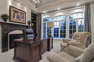 Office area with built in features and a chandelier