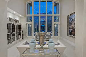 Living room with a high ceiling, carpet, and recessed lighting