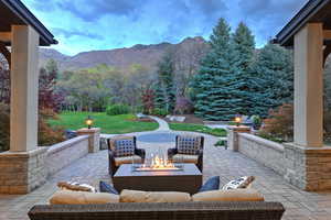 View of patio / terrace with a mountain view and an outdoor living space with a fire pit
