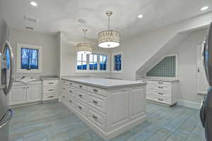 Walk in closet featuring wood finish floors