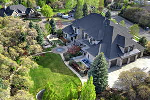 Aerial view of property and surrounding area with a tree filled landscape