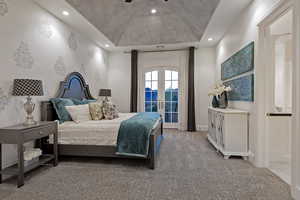 Bedroom with access to outside, french doors, light colored carpet, a tray ceiling, and ceiling fan