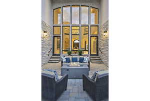 View of patio / terrace featuring entry steps and an outdoor living space with a fire pit