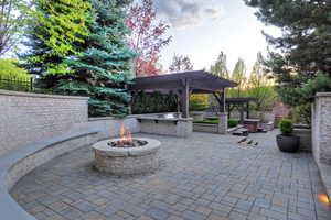View of patio / terrace with an outdoor fire pit and a pergola