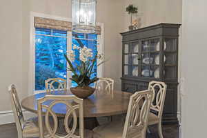 Dining space with baseboards and suspended lighting
