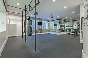 Workout area with dark flooring and recessed lighting
