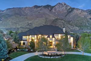 French country inspired facade with a front yard, a chimney, and a mountain view