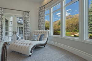 Sitting room featuring french doors, a mountain view, and carpet floors