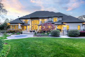 View of front of property with a standing seam roof, roof with shingles, a patio area, and stucco siding