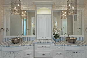 Full bath with suspended lighting and double vanity