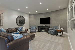 Carpeted living room with recessed lighting and baseboards