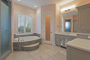 Full bathroom with vanity, a bath, light tile patterned flooring, a stall shower, and recessed lighting