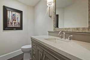 Bathroom featuring vanity and dark wood-style floors