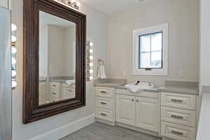 Bathroom featuring two vanities and light wood-style flooring