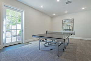 Game room featuring baseboards and carpet