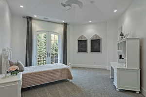 Carpeted bedroom with french doors, access to outside, and recessed lighting
