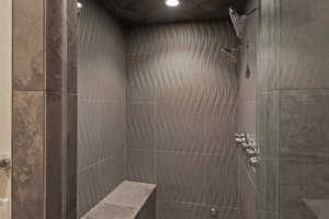 Bathroom with tiled shower and recessed lighting