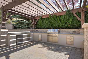 View of patio featuring a pergola and area for grilling