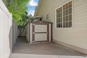 View of shed with a fenced backyard