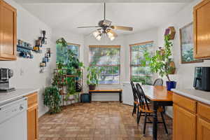 Dining room with brick patterned flooring and ceiling fan