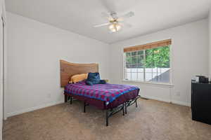 Bedroom featuring light carpet and ceiling fan