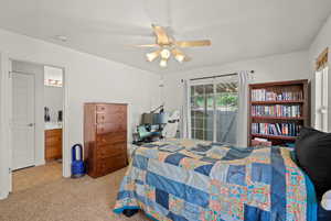Bedroom featuring ceiling fan, access to outside, connected bathroom, and carpet floors
