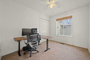 Office featuring light carpet and a ceiling fan