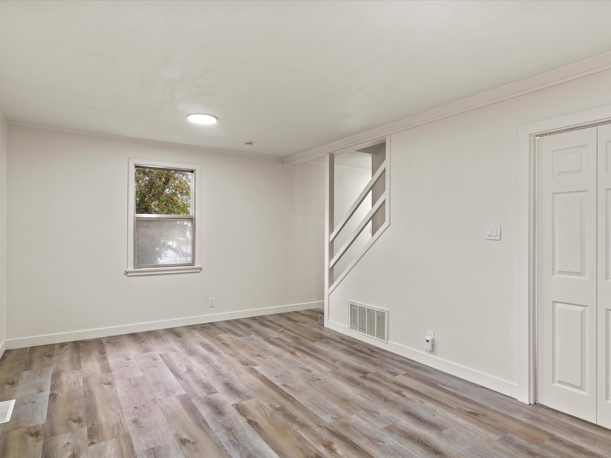 Below grade area with light wood finished floors and crown molding