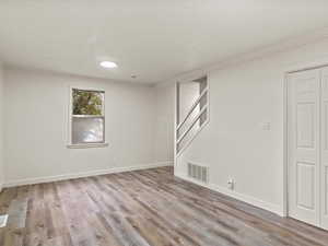Below grade area with light wood finished floors and crown molding