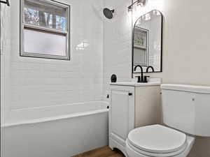 Bathroom with vanity, shower / washtub combination, and wood finished floors