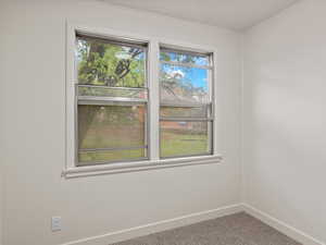 Unfurnished room with baseboards and carpet floors
