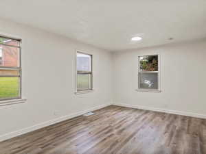 Empty room featuring light wood-style flooring and baseboards