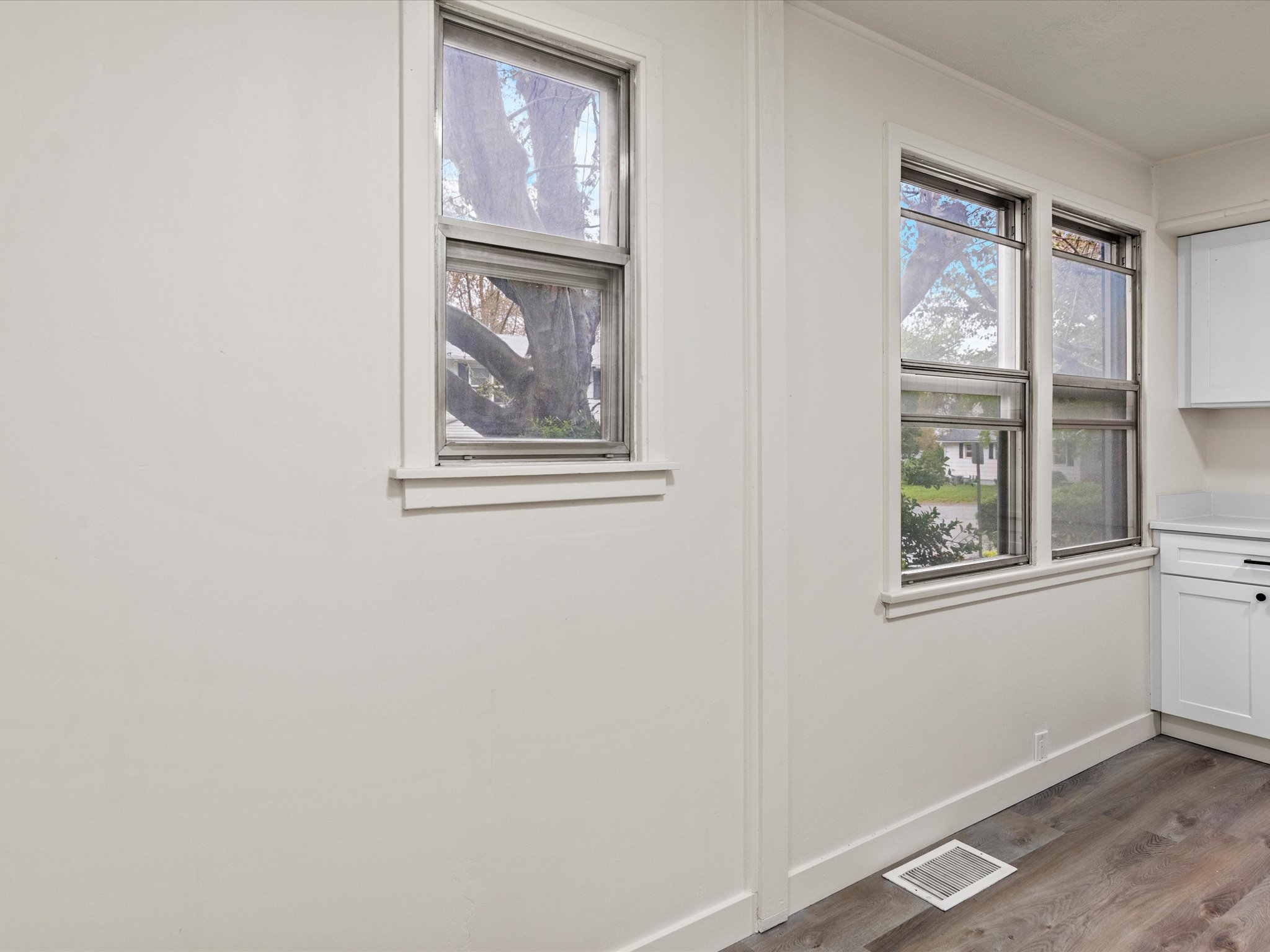 Detailed view of baseboards and wood finished floors