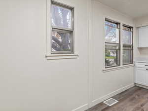 Detailed view of baseboards and wood finished floors