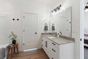 Full bath featuring ensuite bath, vanity, dark wood-style flooring, and a garden tub
