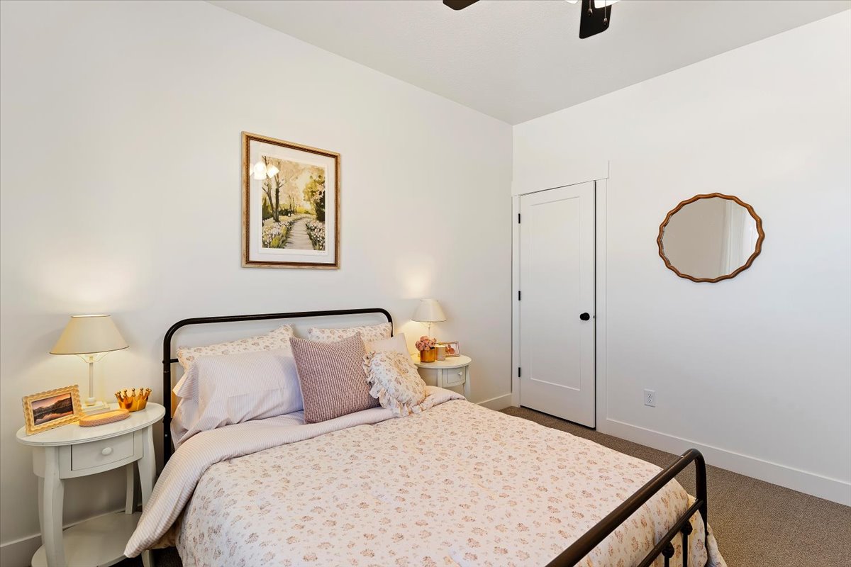 Bedroom featuring dark carpet and a ceiling fan
