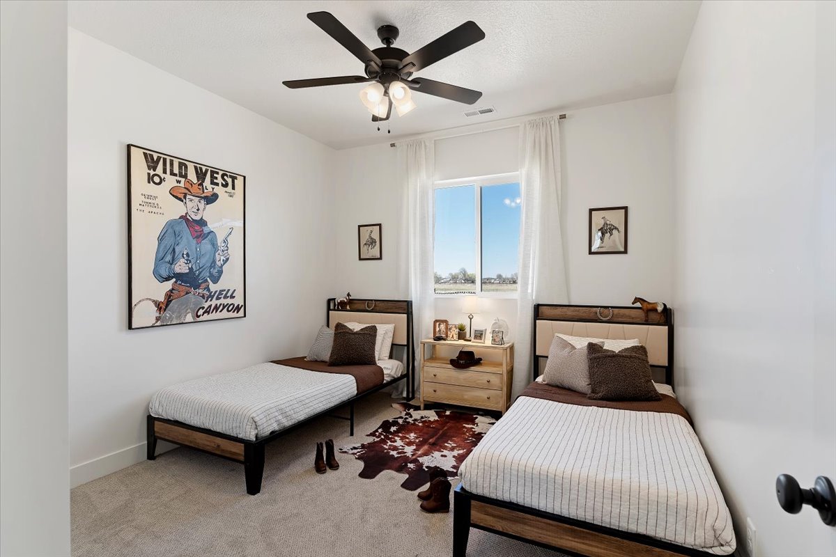 Bedroom with carpet floors and a ceiling fan