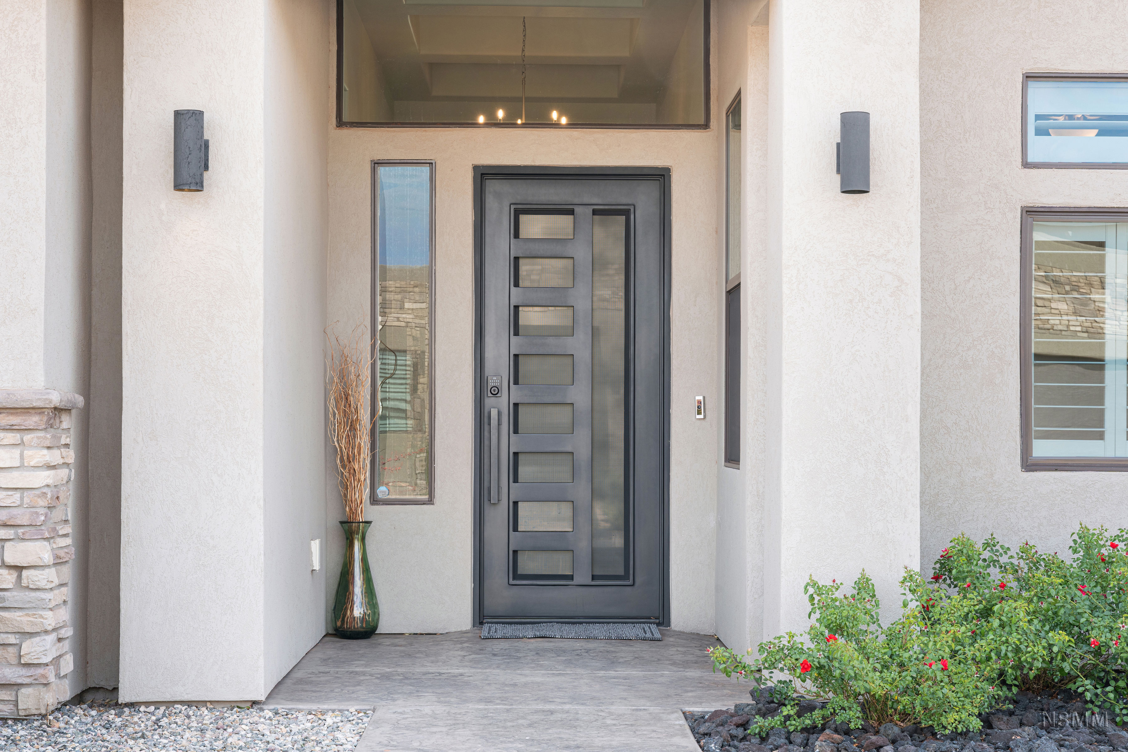 View of exterior entry featuring stucco siding