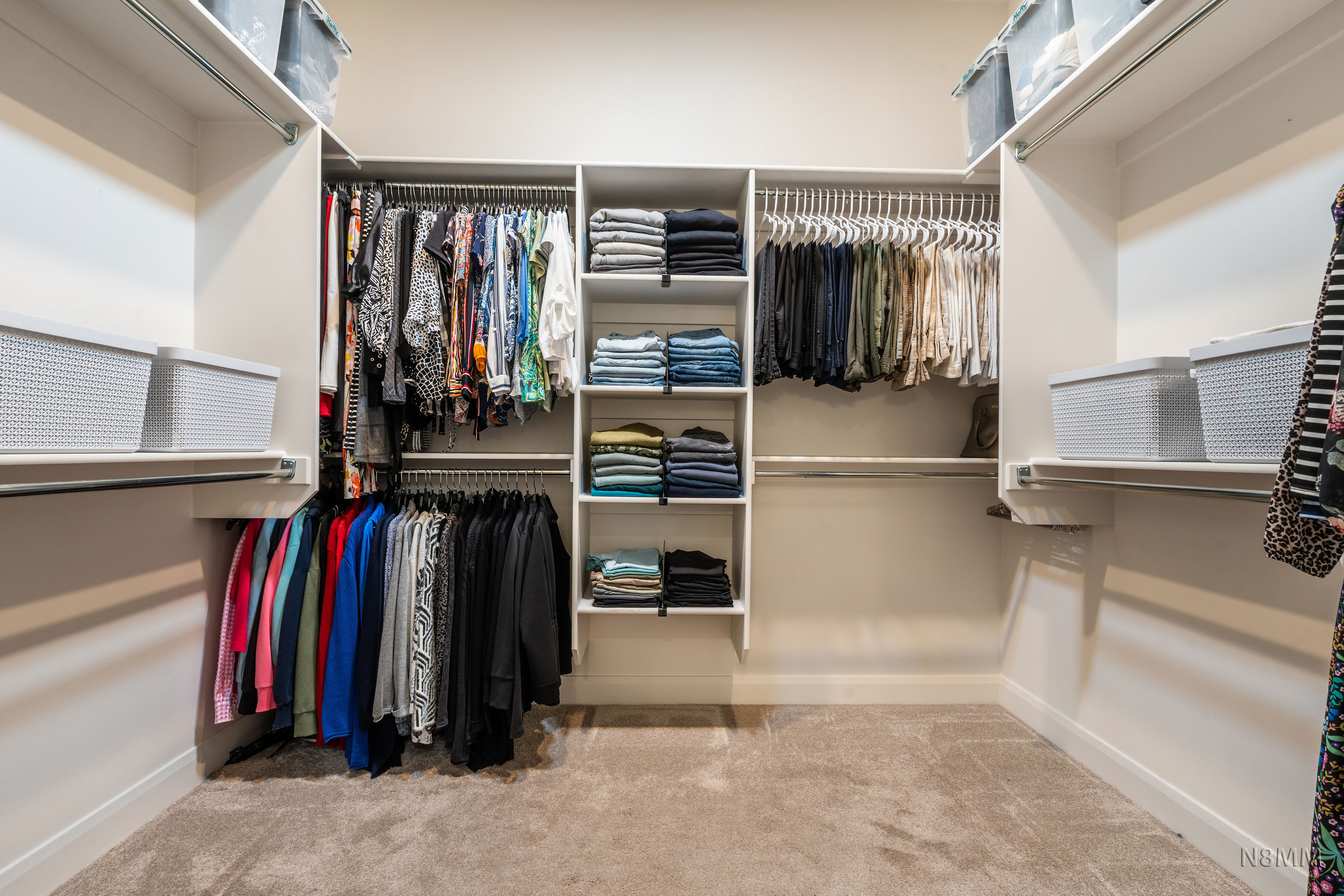 Walk in closet featuring light colored carpet