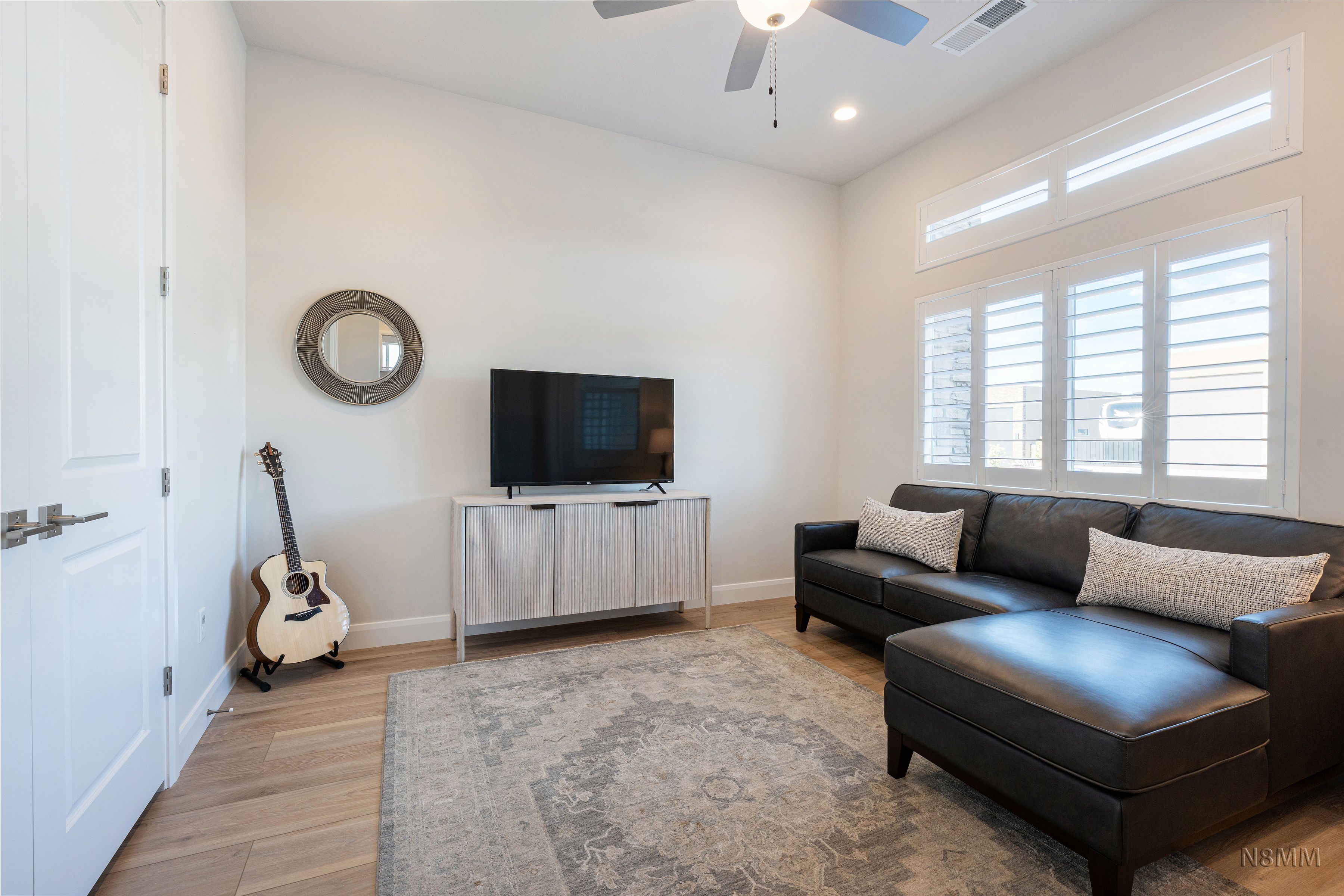Living room featuring ceiling fan, light wood-style floors, and recessed lighting