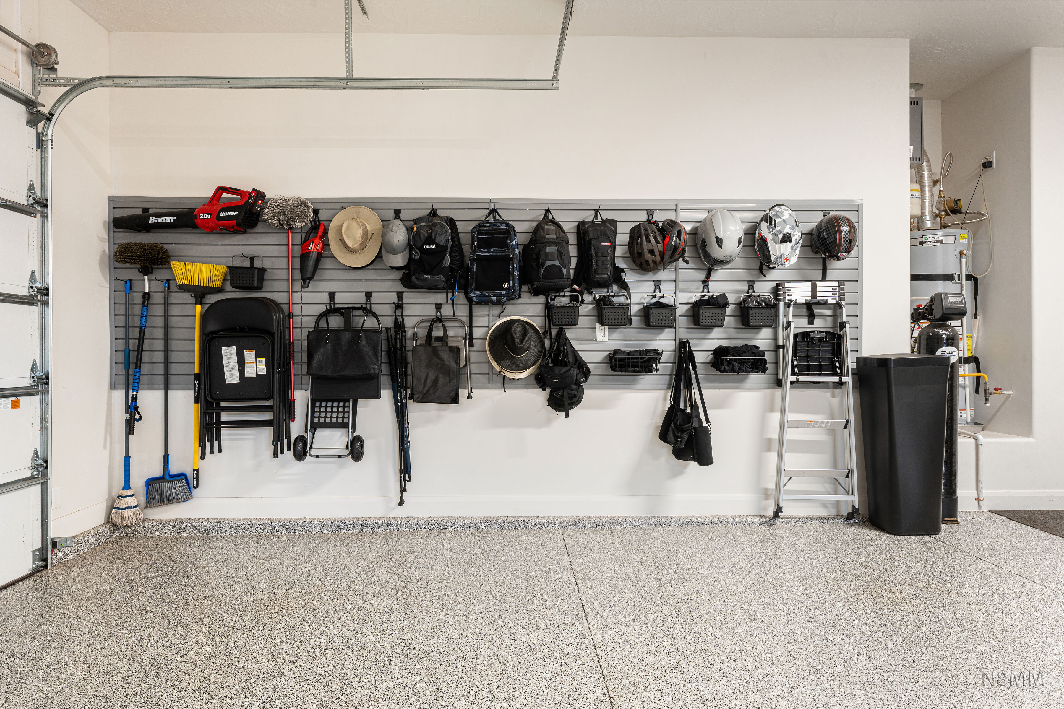 Garage featuring water heater and baseboards