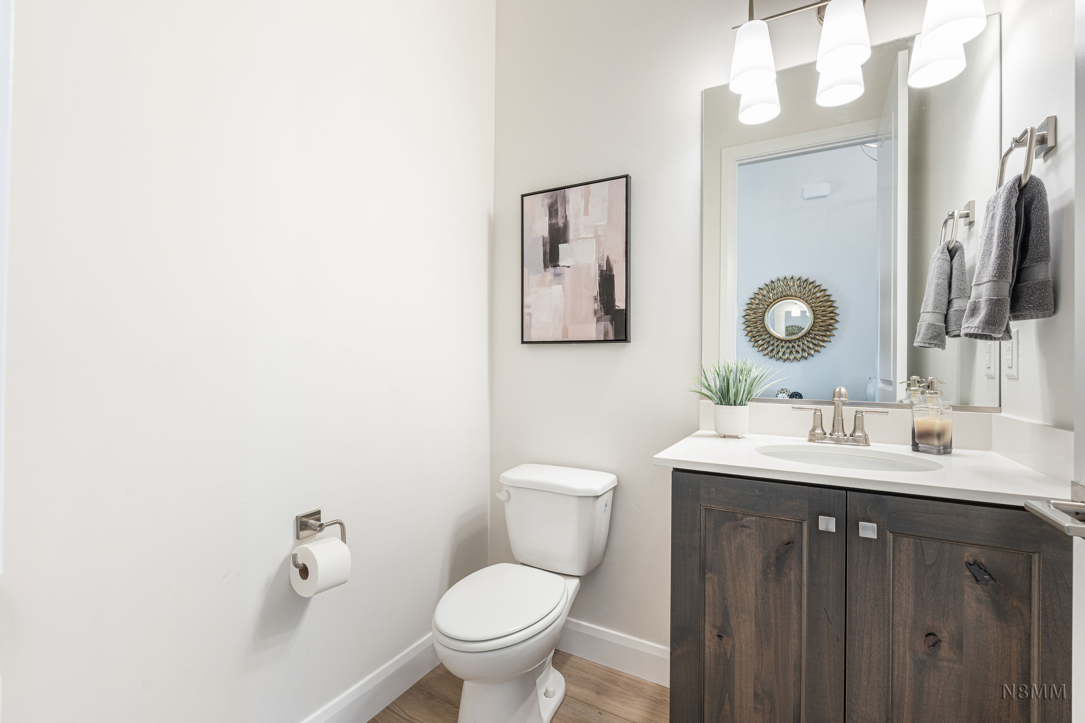 Half bathroom featuring vanity and light wood-style flooring