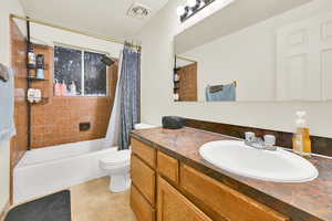 Full bath featuring vanity, shower / tub combo