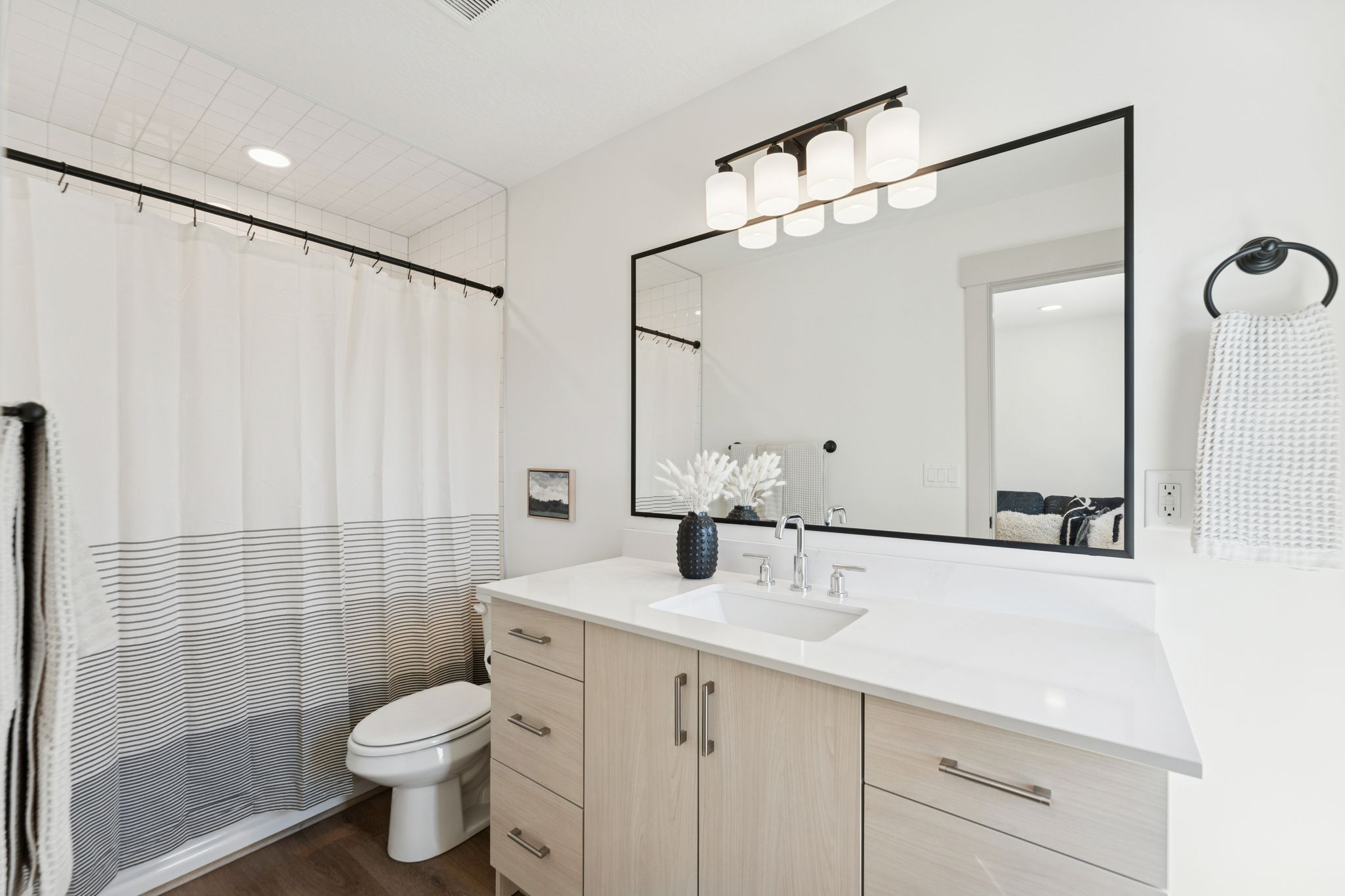 Full bath with vanity, dark wood-type flooring, and recessed lighting