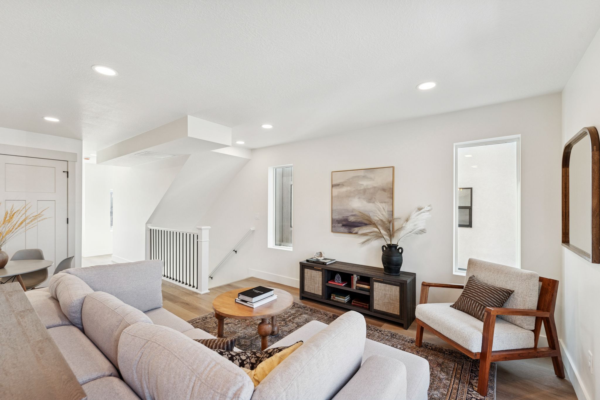 Living area with wood finished floors and recessed lighting