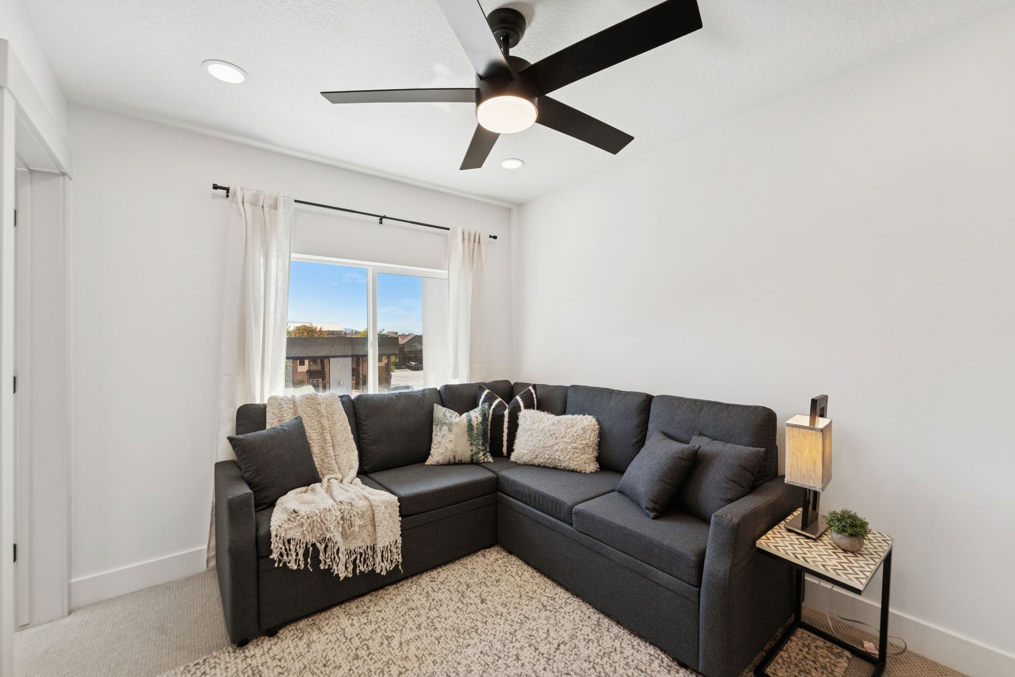 Living room featuring ceiling fan, carpet floors, and recessed lighting