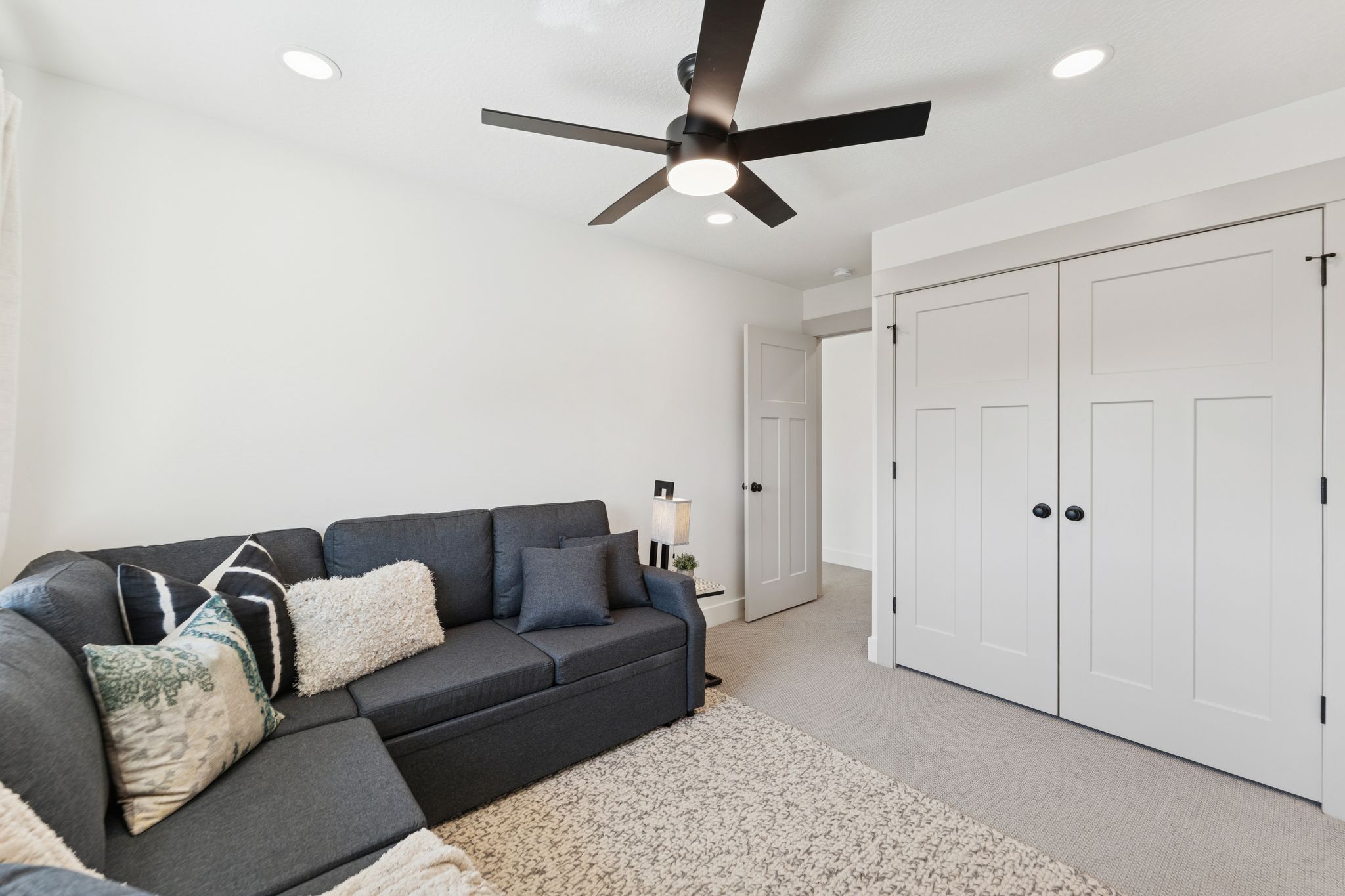 Living room featuring light carpet, ceiling fan, and recessed lighting