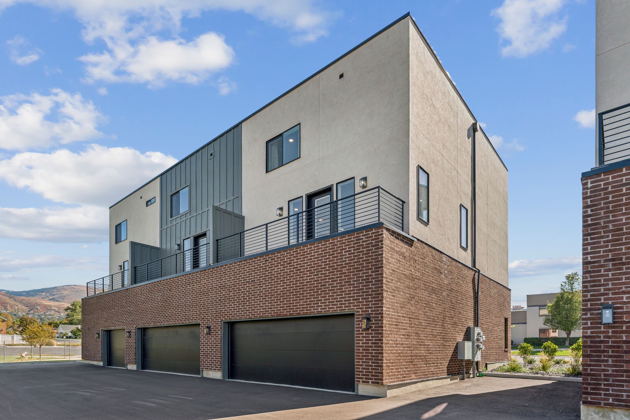 View of apartment building / complex featuring an attached garage