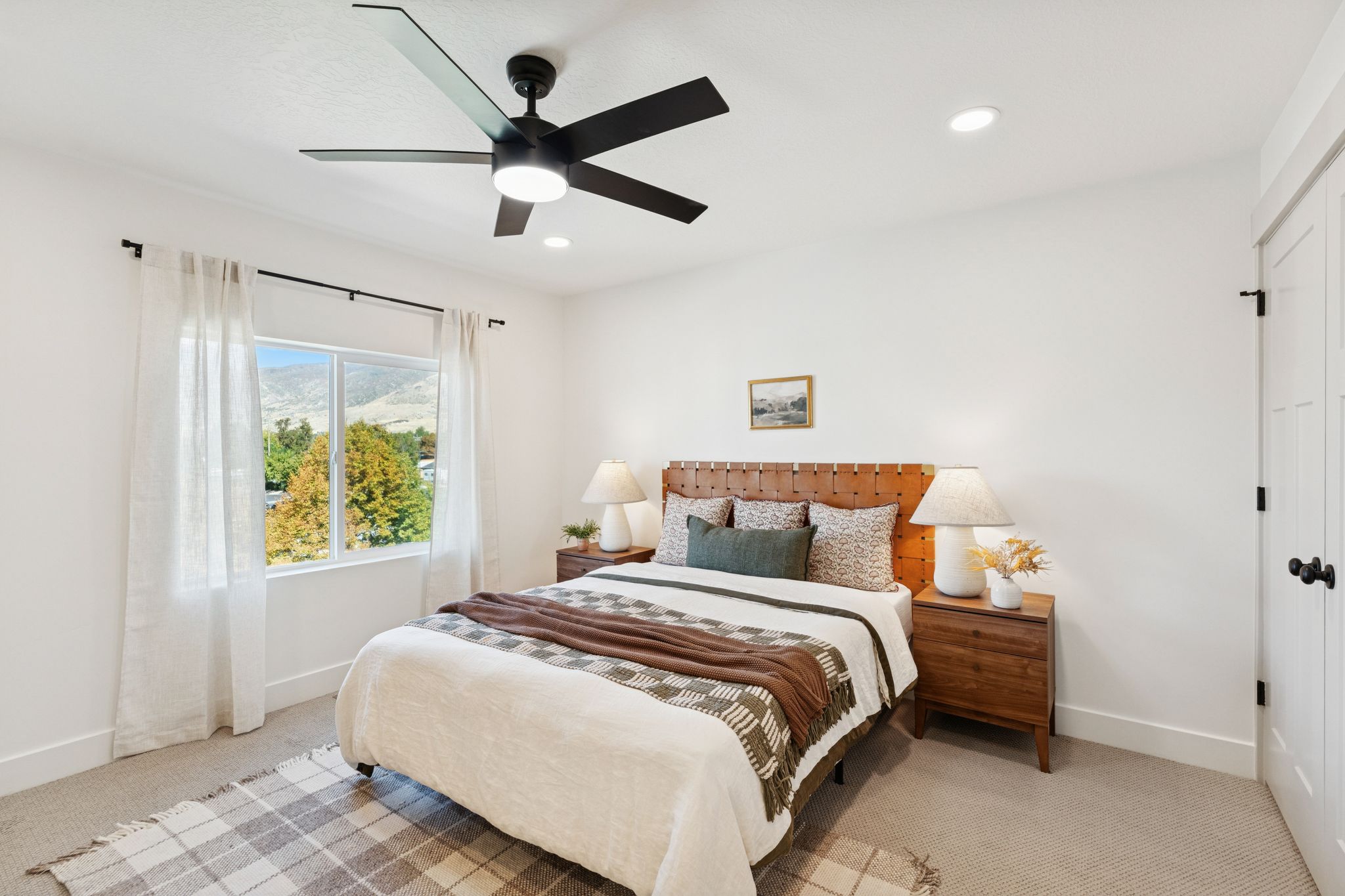 Bedroom featuring light carpet, ceiling fan, a closet, a mountain view, and recessed lighting