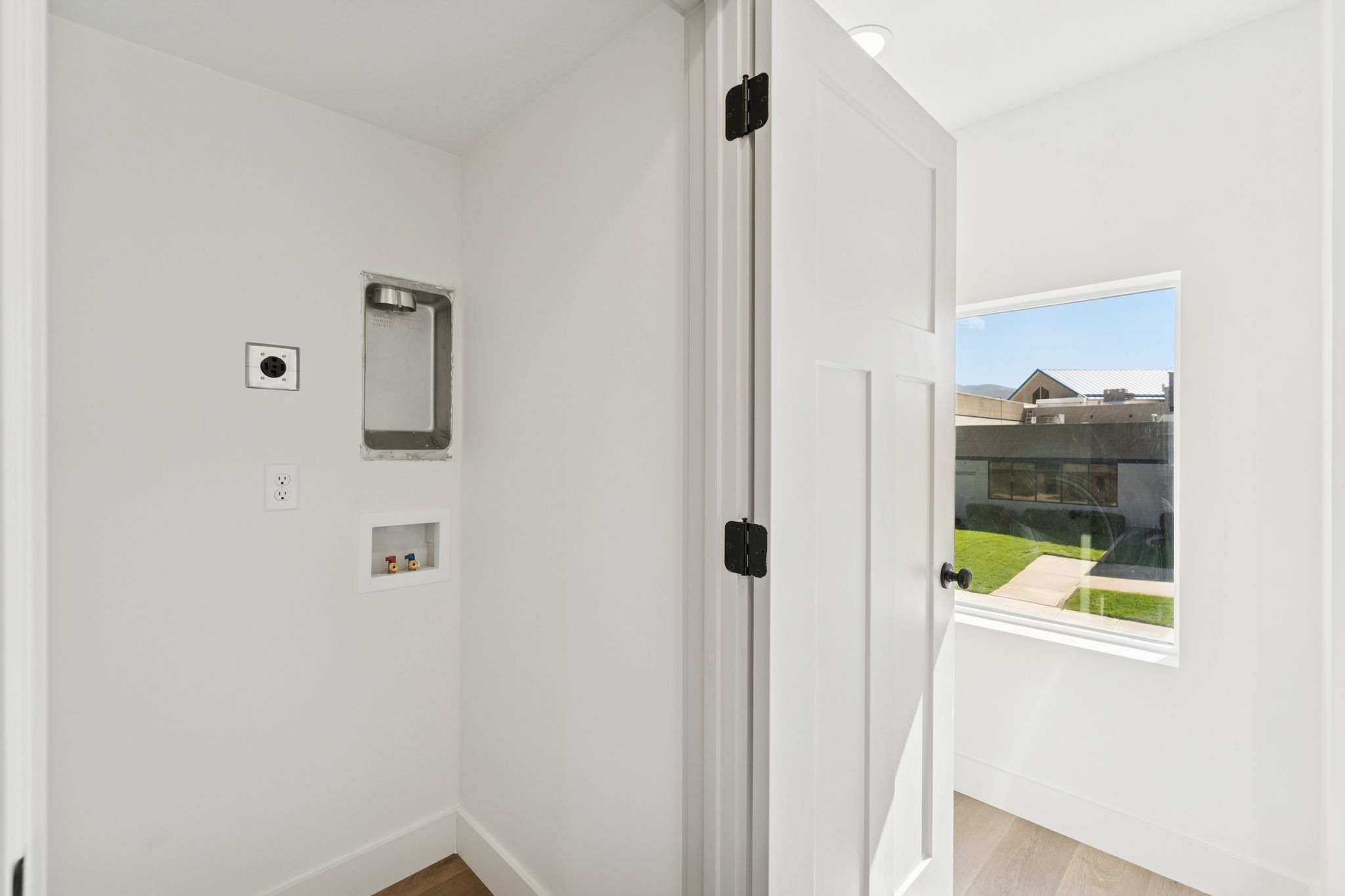 Laundry area with washer hookup and light wood-style flooring
